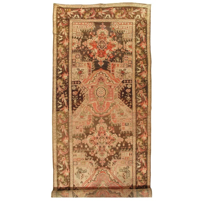 The central panel with a repeating open geometric design with diamond-shaped reserves and oval discs at the corners on a...