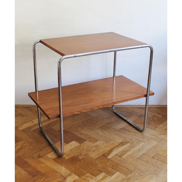 The table's construction recalls breuer's iconic b12 and b22 models produced by thonet. Like those celebrated designs, it...
