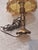 Vintage boudoir table lamp featuring a beautifully detailed brass-tone base paired with a cream satin shade adorned with...