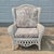This is a charming white wicker wingback lounge chair with generous proportions and lattice detailing. The cushions are...