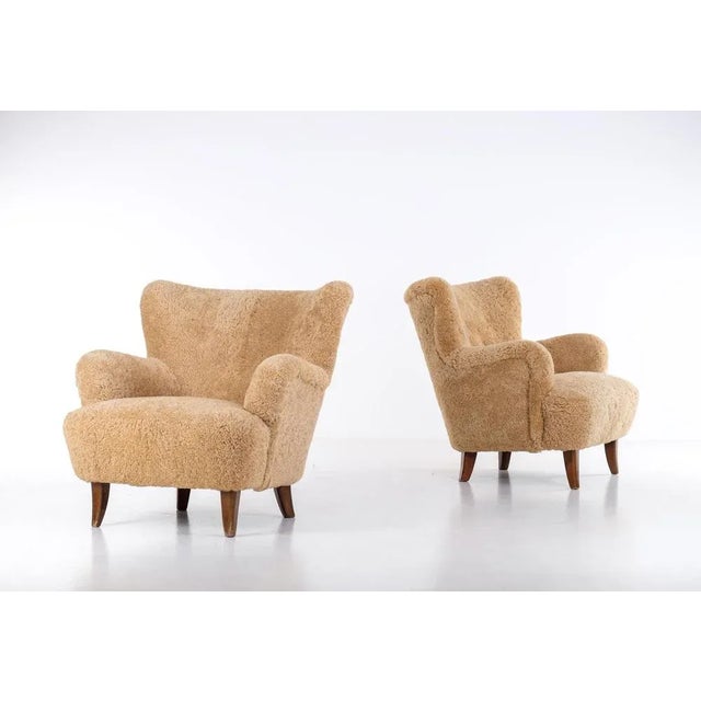 Excellent condition. Newly reupholstered in honey colored sheepskin. This piece is attributed to the mentioned...