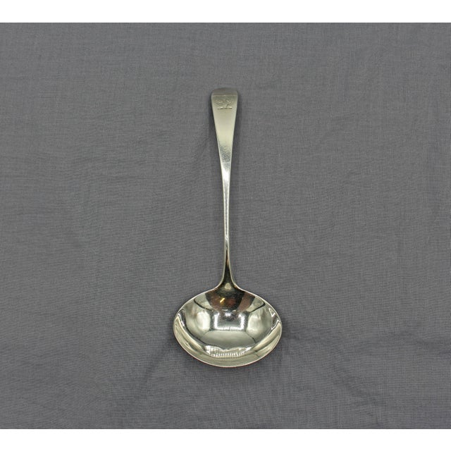 George III sterling silver gravy ladle, London, 1810. Crest. Maker HP & C unlisted. well shaped oval bowl. 1.35 troy oz....