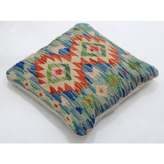 A one-of-a-kind handwoven Afghan wool kilim accent pillow featuring twin diamond medallions on cream. Cut and sewn by hand...