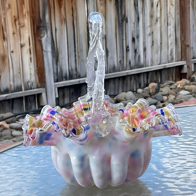 This is a Victorian Handblown Ruffled Basket by Stevens and Williams. The basket is cased glass with splatter glass...