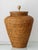 Hand-woven rattan table lamp from Burma (now Myanmar), 1980s, in the form of a lidded storage jar rooted in the country's...