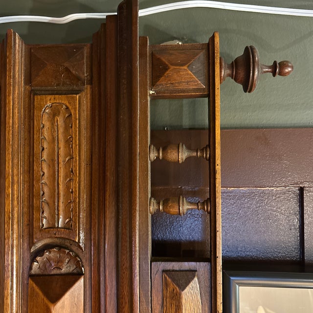 A handsome antique Henry II style French mantel mirror crafted in walnut, featuring turned columns, raised geometric...