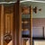 A handsome antique Henry II style French mantel mirror crafted in walnut, featuring turned columns, raised geometric...
