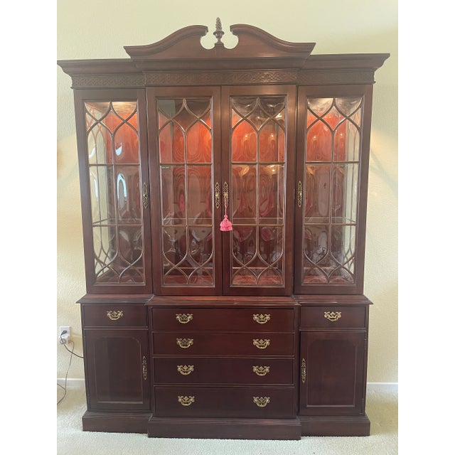 1998 Knob Creek Breakfront China cabinet with three lights and curved glass in doors. Dark finish not cherry finish. Could...