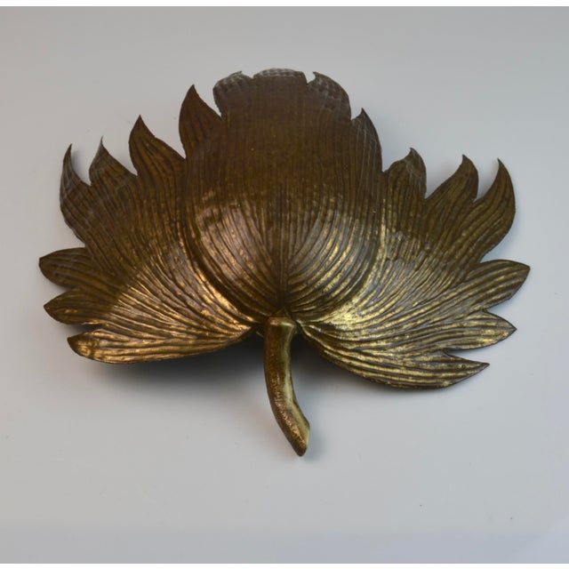 Elegant sculptural wall sconce in gilt brass designed as a stylized plane tree leaf. The deeply incised veining and...