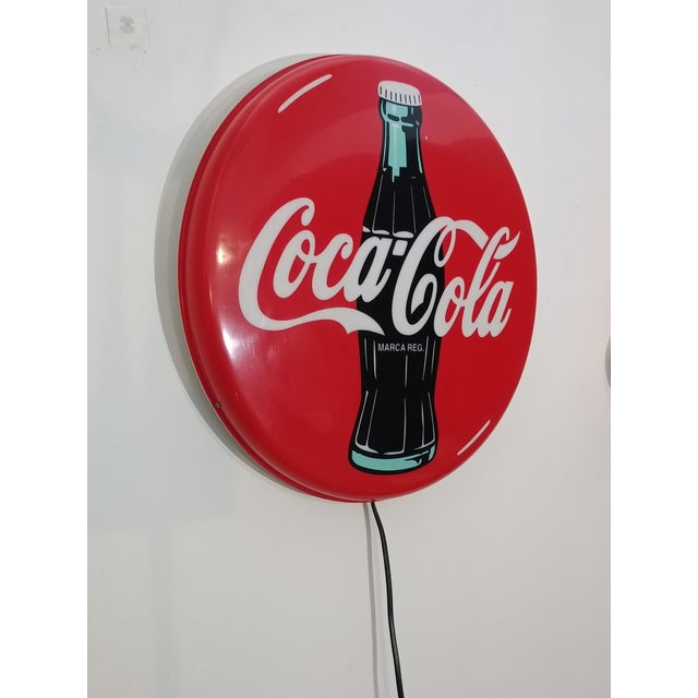 Authentic Coca-Cola illuminated sign. Produced in 1997. Round model with original bottle outline and MARCA REG marking....