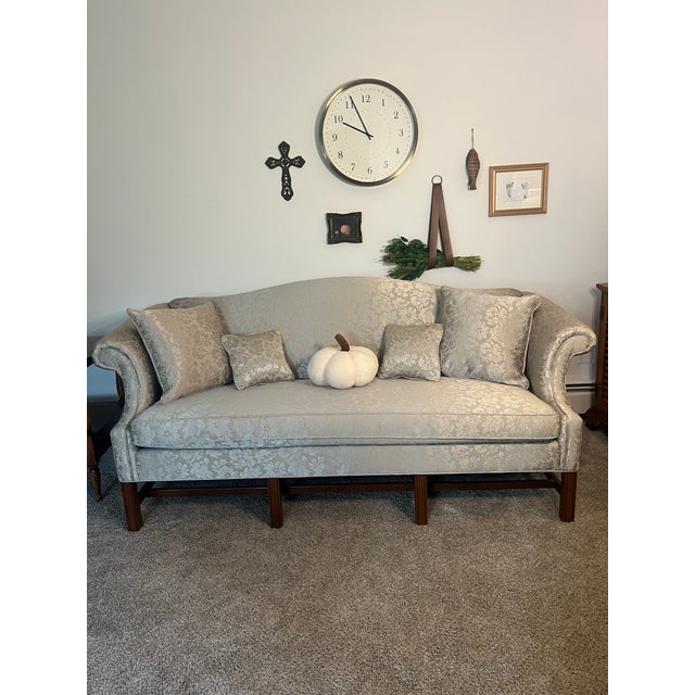 Excellent condition, like new. This heirloom-quality piece has been professionally reupholstered in sage green damask...