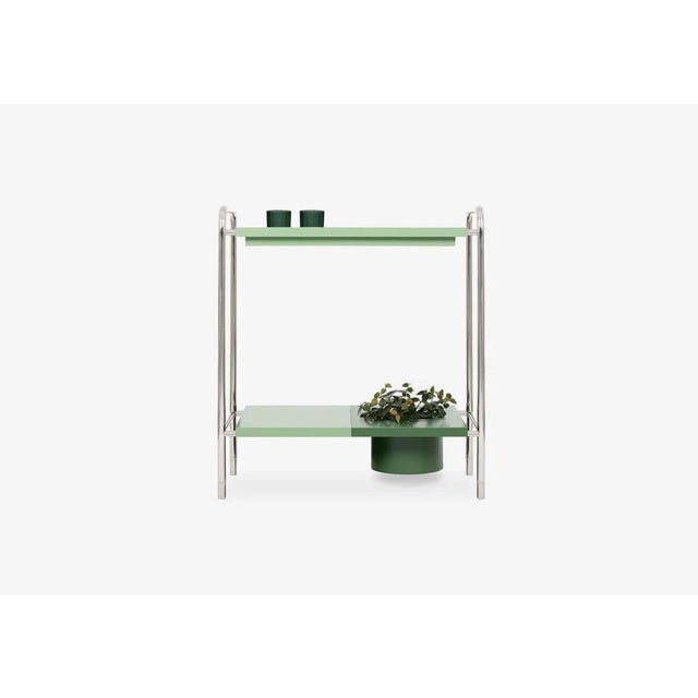 Console table composed of 1 polished stainless steel structure with fixed feet and 3 tops in lacquered MDF. The Living...