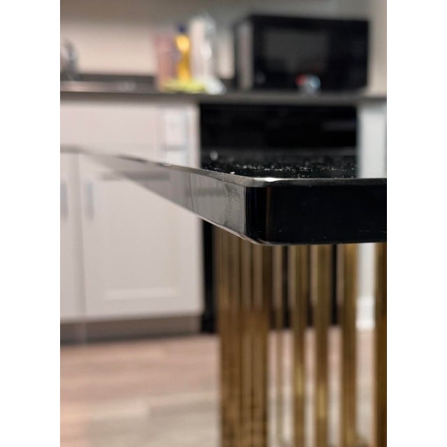This table was purchased in 1980 in Long Island. The top is thick glass sitting on 2 independent bases made of brass. It...