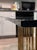 This table was purchased in 1980 in Long Island. The top is thick glass sitting on 2 independent bases made of brass. It...