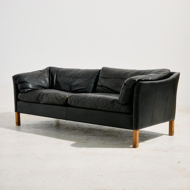 Danish leather sofa from the 1970s produced by Nielsen. The base is made of beech and covered with comfortable leather...