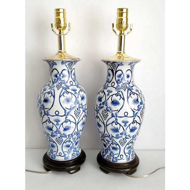 Offering a restored vintage blue and white hand painted Chinese porcelain table lamps, circa Mid 20th Century. The...