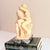 A romantic figural sculpture in the manner of Rodin's "The Kiss," carved in the alabaster-resin technique by Italian...