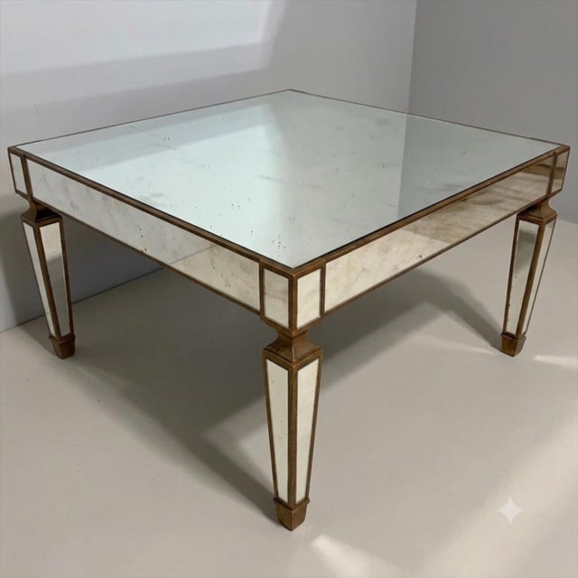 This is a Hollywood Regency Era mirrored Italian coffee table. The frame is giltwood. It is in very good condition and...