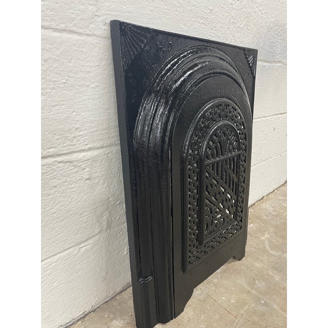 A remarkable piece of Southern architectural history, this late 19th-century cast iron fireplace surround and matching...