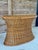 Stunning vintage rattan console table featuring an elegant hourglass silhouette and beautifully detailed braided trim....
