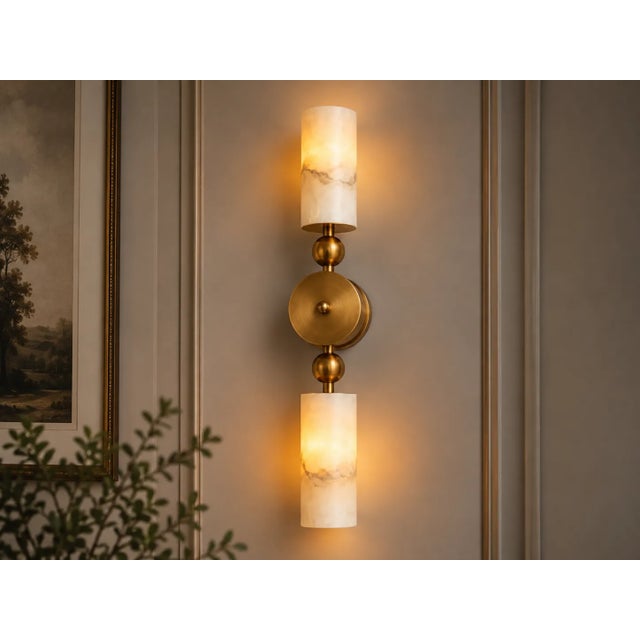 Bring sculptural warmth and natural stone character to your interior with this handcrafted double wall sconce, featuring...