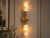 Bring sculptural warmth and natural stone character to your interior with this handcrafted double wall sconce, featuring...