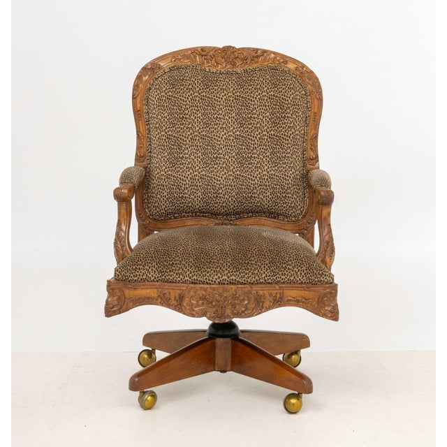 Louis XV Style Leopard Print Upholstered Walnut Swivel Chair, the frame ornately carved with shell and foliage motifs and...