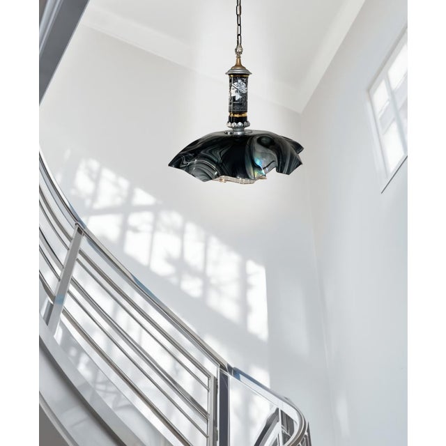 This one‑of‑a‑kind mixed‑media pendant light stands 23 inches tall (excluding the chain) with a sculptural shade measuring...
