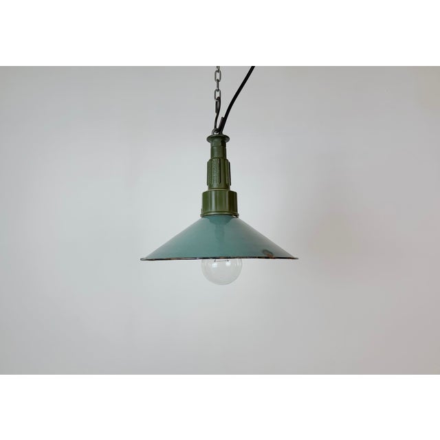 Industrial petrol enamel pendant light made in Poland during the 1960s. White enamel inside the shade. Green cast...