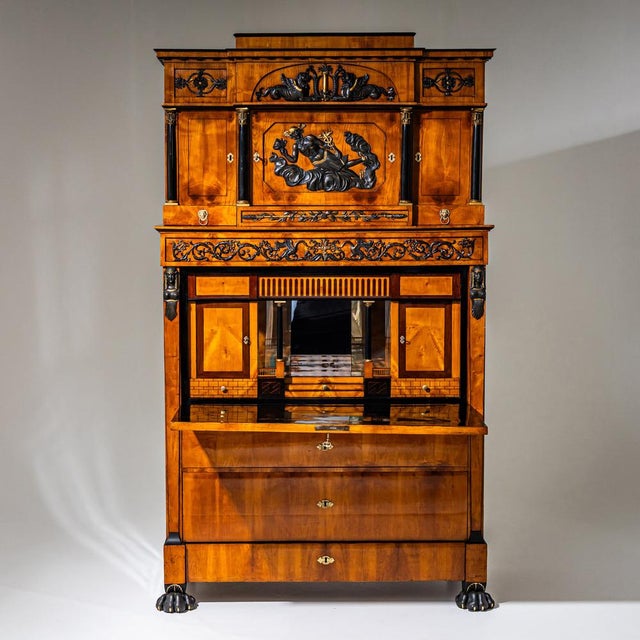 Large Empire secretary in the so-called Retour d’Égypte style, raised on blackened and partially gilded paw feet. The...
