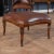 The Fireside Chair Ottoman with Leather is a hand carved, American style bench carved from solid, kiln dried, plantation...