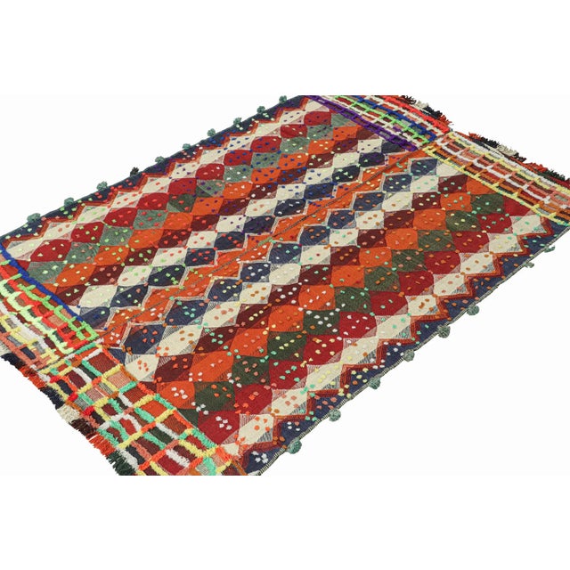 This vintage 6x9 Persian kilim rug is handwoven in wool, and originates circa 1950-1960. Its design is a panel-weave, in...