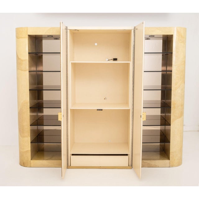 Karl Springer Style Faux Travertine Display Cabinet, the central two-door cabinet with four shelves flanked by two lighted...