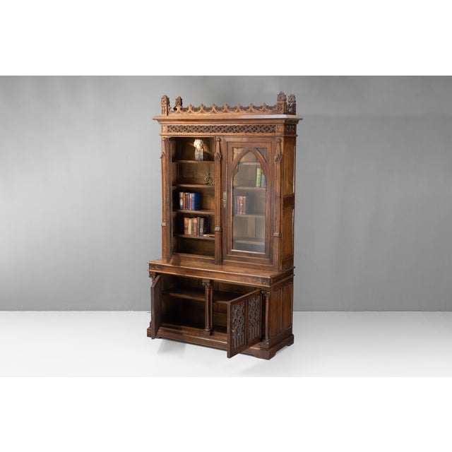 Two door gothic style bookcase in oak with arched glazed upper doors. Circa 1880.