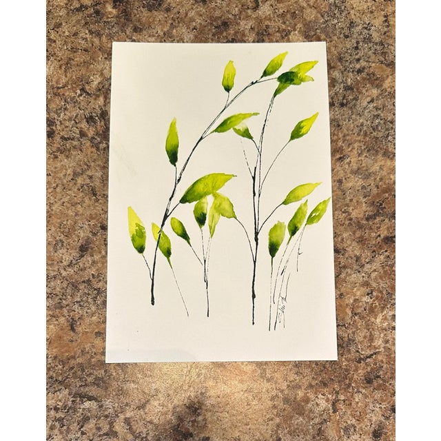 Fresh green leaves climb upward on graceful stems, embodying renewal, hope, and the promise of growth.