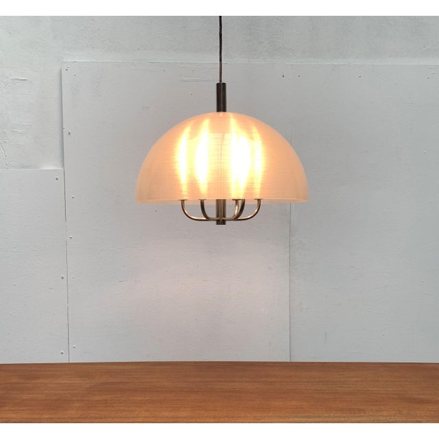 Imposing pendant lamp with plastic shade. Probably of Italian origin. This design convinces by combining classic elements...