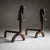 Set of iron andirons featuring stylized horse head finials.
