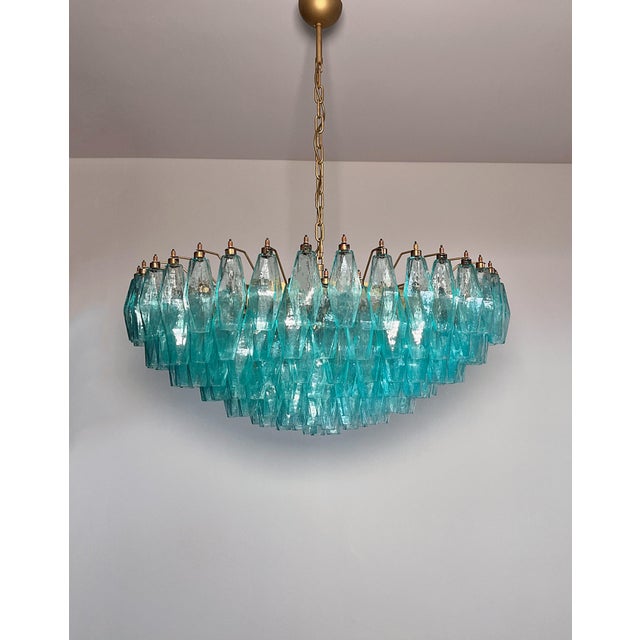 Elegant Italian pendant light made from 185 Turquoise Murano glasses "poliedri". Structure in gold and brass colored...