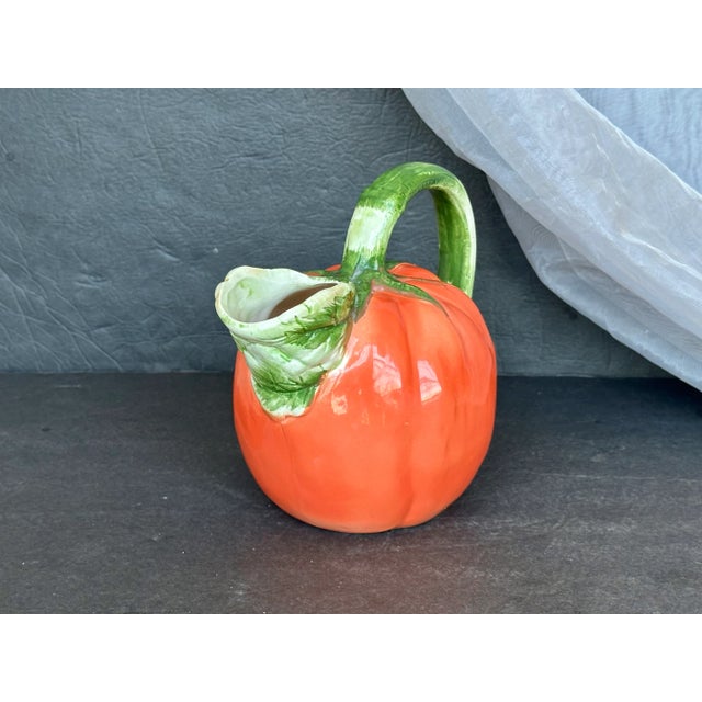 Display this vintage ceramic tomato pitcher as decor in a country kitchen or fill it with flowers and use it as a dining...