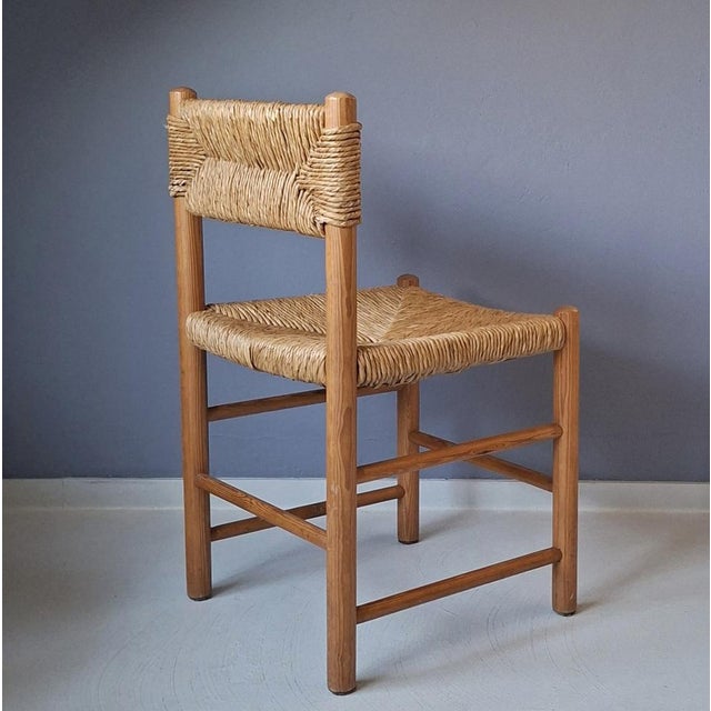 This 60s chair with rush seat and backrest is attributed to Charlotte Perriand ("Dordogne" chair). The chair, wood and...