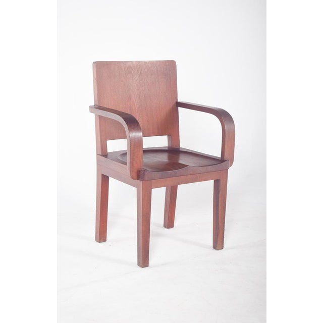 Mahogany armchair. with a robust design and straight lines, typical of institutional environments or 20th century offices....