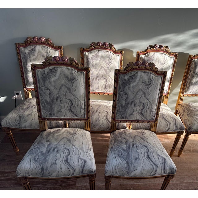 These Louis XVI-style chairs feature classic fluted legs and have been reupholstered in a distinctive swirling, marbled...