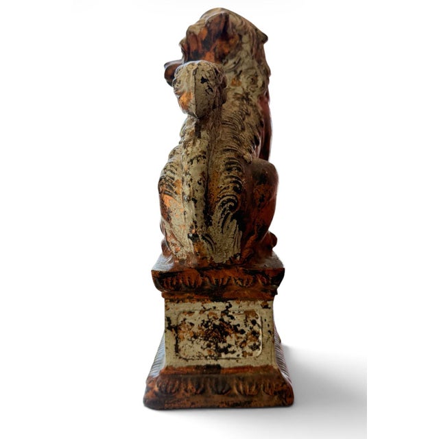 Striking matched pair of vintage Japanese cast-metal guardian lion figures, or foo dogs, presented on decorative pedestal...