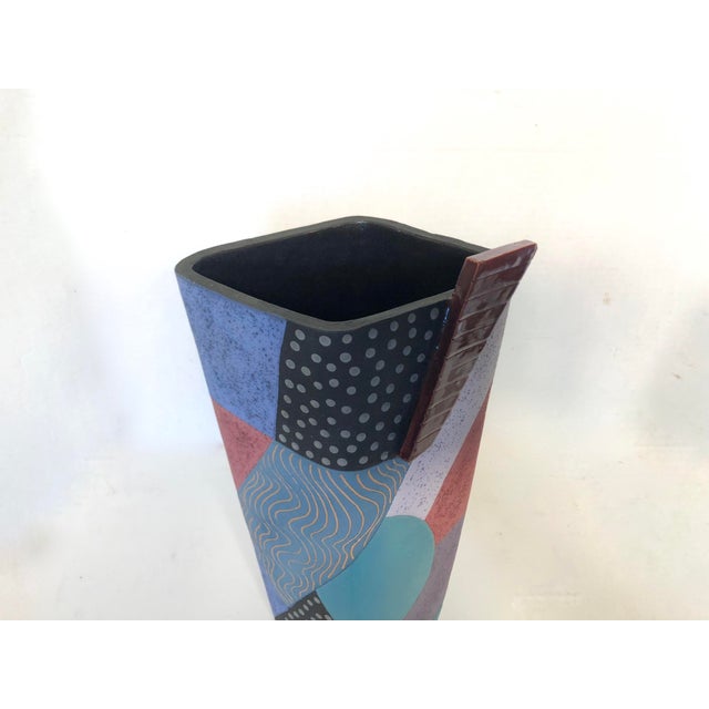 Unique piece of 1980's Memphis styled studio pottery. Features irregular shape with a blocked geometric pattern done in...