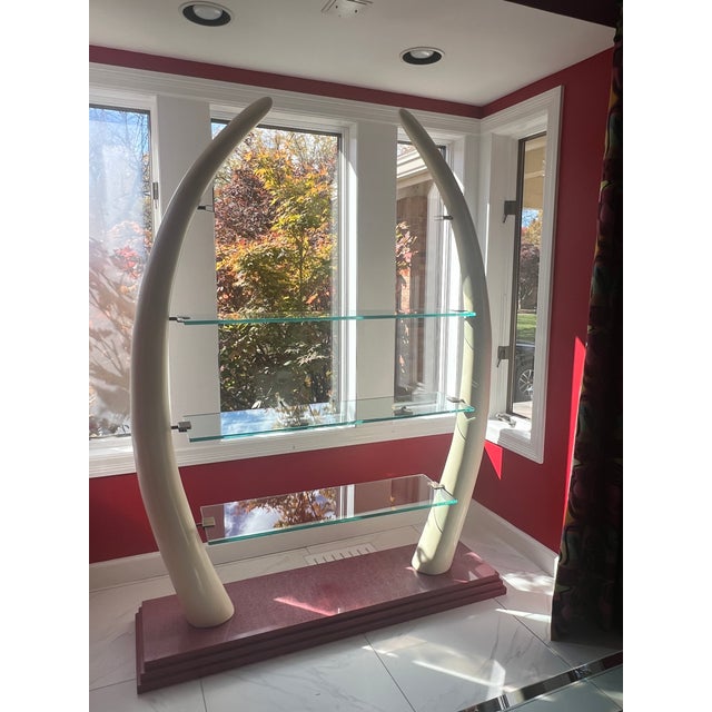 This item was acquired in the late 1960's, new. Unlike other similar item this etagere has a red stone base. The tusks are...