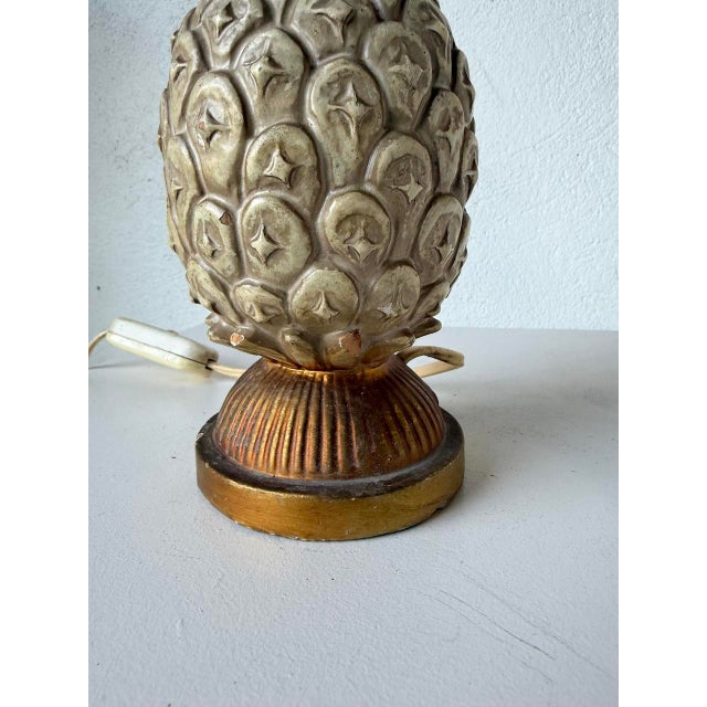 Old terracotta “pineapple” motif lamp base, ivory and gold in color. Chips at the back and on the ears. Please refer to...