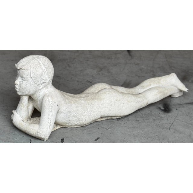 American Art Deco Style Cast Stone Garden Sculpture of a Daydreaming Youth, Circa 1950s A charming and contemplative...
