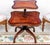 A beautifully made antique two tier table with a leather top. This is in the Regency style, it dates from around the...