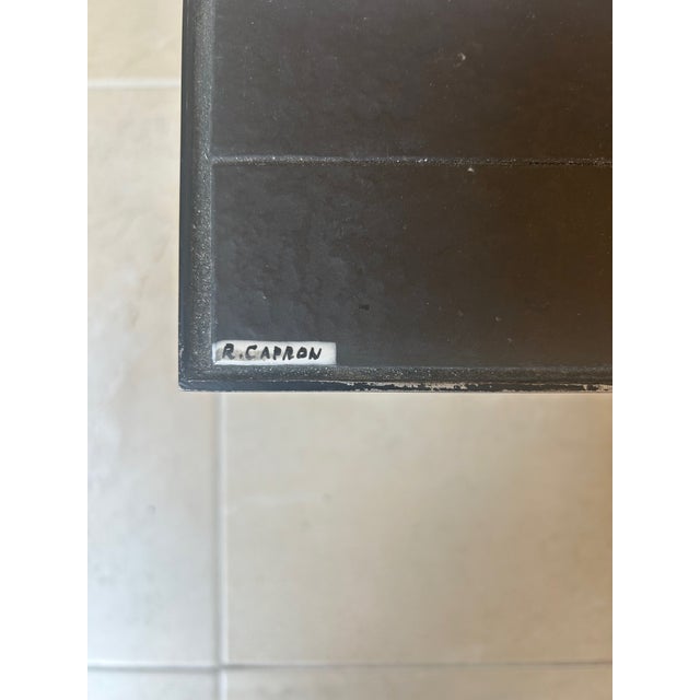 The surface is made of black, white, red and orange glazed slate. Signed in the left corner. This piece has an attribution...