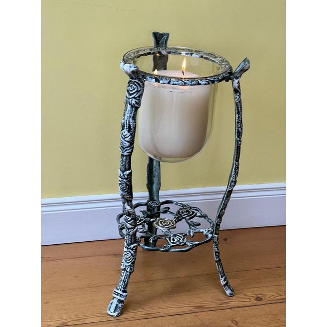A large cast iron and glass antique indoor/outdoor candle holder/uplighter